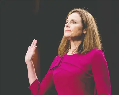  ?? ERIN SCHAFF / POOL VIA REUTERS ?? U.S. Supreme Court nominee Amy Coney Barrett is sworn in Monday before the Senate Judiciary Committee
in Washington. In prepared statements, Coney Barrett said, she would apply the law “as written.”
