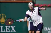  ?? The Associated Press ?? John Isner returns to Diego Schwartzma­n at the BNP Paribas Open on March 15 in Indian Wells, Calif. At 37, Isner is just happy to be back on tour in Europe with his wife and three kids. No longer dreaming of a Grand Slam title, he’s trying to make the back end of his tennis career not seem “like such a job.”