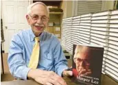  ?? JAY REEVES/AP ?? Historian Wayne Flynt holds a copy of his book “Afternoons with Harper Lee,” about the author of “To Kill a Mockingbir­d” who died in 2016, on Sept. 22 in Alabama.