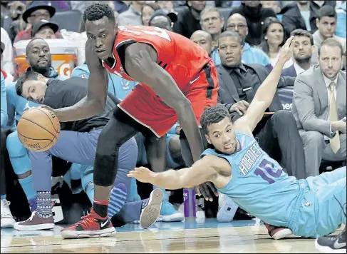  ?? AP ?? Raptors’ Pascal Siakam drives past a tumbling Michael Carter-Williams during last night’s win over the Hornets in Charlotte.