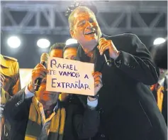  ?? AFP ?? Ecuadoran presidenti­al candidate of the ruling Alianza PAIS party, Lenin Moreno shows a sign that reads ‘Rafael, we are going to miss you’ during a celebratio­ns in Quito.