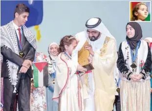  ??  ?? Sheikh Mohammed pacifies the winner Maryam Amjoun (inset) after she turns emotional during the prize distributi­on ceremony on Tuesday. The photograph also shows the other winners of the competitio­n. MORE: P2