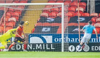  ??  ?? Alex Iacovitti fires home County’s second goal past Tangerines keeper Deniz Mehmet.