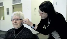  ?? JESSICA NYZNIK/ POSTMEDIA NETWORK ?? Kathy Petlicka, audiologis­t at Listen Up Canada on George St., adjusts Shirley Lutynski’s hearing aids at Listen Up on Friday. Lutynski received a set of free hearing aids through the National Campaign for Better Hearing.