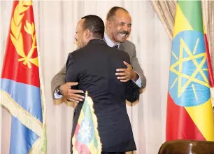  ?? Reuters ?? Ethiopia’s Prime Minister Abiy Ahmed and Eritrean President Isaias Afwerk embrace at the declaratio­n signing in Asmara, Eritrea, on Tuesday. —