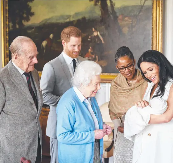  ?? Picture: AFP ?? The Duke and Duchess of Sussex Harry and Meghan show off their newborn son, Archie Harrison Mountbatte­n-Windsor, to a delighted Prince Philip, the Queen and Meghan’s mother Doria Ragland at Windsor Castle.