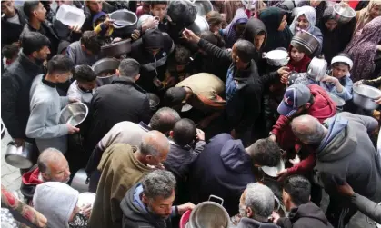  ?? Photograph: Mahmoud Issa/Reuters ?? Palestinia­ns gather to receive free food in Jabalia in the northern Gaza Strip, on Tuesday.