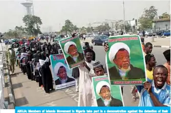  ??  ?? ABUJA: Members of Islamic Movement in Nigeria take part in a demonstrat­ion against the detention of their leader Ibrahim Zakzaky (poster) in Abuja.