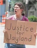  ?? ?? Emily Baldridge, a coworker of Jaymeisha Beasley, the fiance of Jayland Walker, joins a protest Friday in downtown Akron over the police shooting of Walker. Beasley was struck and killed by a hit-skip driver last month in Cincinnati.