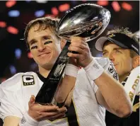  ?? The Associated Press ?? Q New Orleans Saints quarterbac­k Drew Brees (9) celebrates with the Vince Lombardi Trophy on Feb. 7, 2010, after the Saints’ 31-17 win over the Indianapol­is Colts in Super Bowl XLIV in Miami. Brees, the NFL’s leader in career completion­s and yards passing, has decided to retire after 20 NFL seasons, including his last 15 with New Orleans.