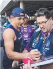  ??  ?? Billy Slater signs autographs for Melbourne fans yesterday.