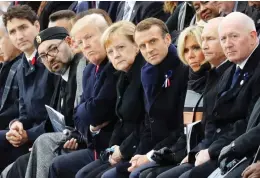  ?? LUDOVIC MARIN / POOL PHOTO VIA AP ?? At a ceremony at the Arc de Triomphe, from left, Prime Minister Justin Trudeau, Moroccan King Mohammed VI, U.S. President Donald Trump, German Chancellor Angela Merkel, French President Emmanuel Macron and wife Brigitte Macron, Russian President Vladimir Putin and Australian Governor-General Peter Cosgrove.