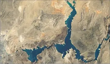  ?? NASA ?? LAKE MEAD in an August 2000 satellite image. The last time the reservoir approached full capacity was in the summer of 1999. Projection­s for next summer say Lake Mead’s level could fall by an additional 20 feet.