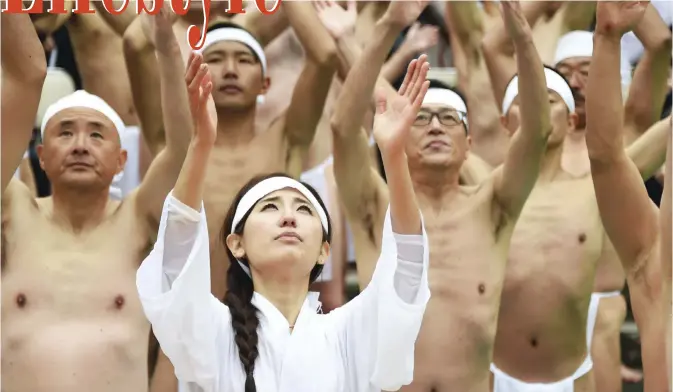  ??  ?? Shinto believers of the Teppozu Inari Shrine pray after bathing in cold water to purify their souls and bodies during a New Year event in Tokyo yesterday. Some 100 Shinto believers took part in the annual new year purificati­on event. — AFP