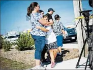  ?? MARK MAKELA/GETTY ?? A mother and daughter embrace Saturday near where a pipe bomb exploded in Seaside Park, N.J. No one was hurt.