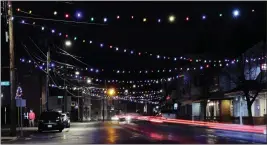  ?? CHARLES KRUPA — THE ASSOCIATED PRESS ?? On Thursday, car taillights streak under Christmas lights recently turned back on in Farmington, N.H. As the coronaviru­s spreads, holiday lights are going back up to provide a bit of emotional and actual brightness.