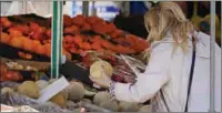  ?? ?? A woman checks the price of a water melon in Essen, Germany