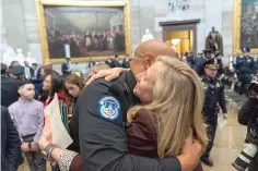  ?? (AP Photo/Alex Brandon) ?? U.S. Capitol Police officer Sgt. Harry Dunn, left, hugs Rep. Abigail Spanberger, D-Va., after a Congressio­nal Gold Medal ceremony Tuesday honoring law enforcemen­t officers who defended the U.S. Capitol on Jan. 6, 2021, in the U.S. Capitol Rotunda in Washington.