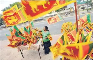  ?? ISHARA S KODIKARA/ AFP PHOTO ?? A vendor sells Sri Lankan national flags at a roadside stall in Colombo.