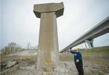  ?? KYLE TELECHAN/POST-TRIBUNE ?? Local labor activist Terry Steagall stands Friday near one of the original remaining pillars as he points out features at one of two proposed sites for a memorial to workers who died in the 1982 Cline Avenue bridge collapse.