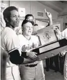  ?? LLOYD PEARSON/BALTIMORE SUN ?? Orioles manager Earl Weaver holds the pennant trophy in the locker room after the final game of the 1970 World Series.