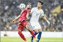  ??  ?? Malaysia’s Irfan Zakaria (right), fights for the ball against Indonesia’s Yabes Roni Malaifani (left), during their men’s football semifinals match at the 29th Southeast Asian Games (SEA Games) at Shah Alam Stadium in ShahAlam, outside Kuala Lumpur on Aug 26. (AFP)