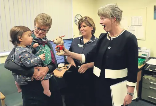  ??  ?? CARE: Health Secretary Shona Robison, right, chats with Jane McNiven and her granddaugh­ter Evie with nurse Eileen McGinness