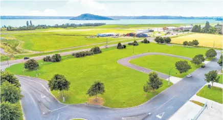  ??  ?? Sections in the Eastgate Business Park with the airport runway and Lake Rotorua in the background (above); NZ Fire services new centre in Eastgate encompassi­ng three buildings and concrete training yard — lower foreground.