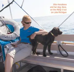  ??  ?? Jitka Hanakova and her dog, Deco, on the Molly V out on Lake Michigan