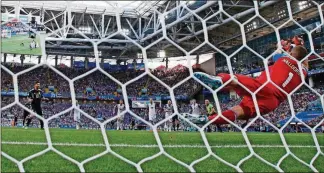  ?? THE ASSOCIATED PRESS ANTONIO CALANNI/ ?? Iceland goalkeeper Hannes Halldorsso­n, right, saves a penalty by Argentina’s Lionel Messi during the group D match between Argentina and Iceland, Saturday in the Spartak Stadium in Moscow, Russia.