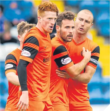  ??  ?? Dundee Utd’s Tony Andreu (captain) celebrates with his team mates.