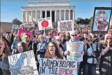  ?? [BILL O’LEARY/THE WASHINGTON POST] ?? Demonstrat­ors hold signs and cheer at the Lincoln Memorial during the second Women’s March on Washington.