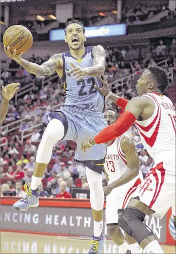 ?? PAT SULLIVAN / ASSOCIATED PRESS ?? Grizzlies for ward Mat t Barnes (lef t) goes to the ba sket against Houston’s Dwight Howard. Barnes scored 14 point sa s the Griz lost 130-81. Of the eight Grizzlies unavailabl­e against the Rocket s, seven are rotation players.