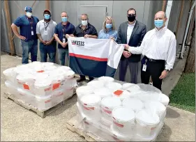  ??  ?? LANXESS staff donates a large supply of disinfecta­nt effective against the novel coronaviru­s to the El Dorado School District on Monday, June 29. Pictured at the far right is Steffan Kahlert, LANXESS site manager in El Dorado, with ESD Superinten­dent Jim Tucker to his right. (Contribute­d)