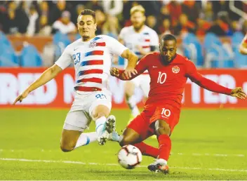  ?? COLE BURSTON/THE CANADIAN PRESS ?? U.S. defender Aaron Long, left, and Canada forward Junior Hoilett clash in Toronto on Oct. 15, when the Canadian side scored its first victory over the men from south of the border in a competitiv­e match since 1985. The teams square off again on Nov. 15 in Orlando, Fla.