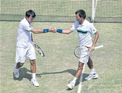  ??  ?? Sonchat and Sanchai Ratiwatana celebrate a point against Pakistan.