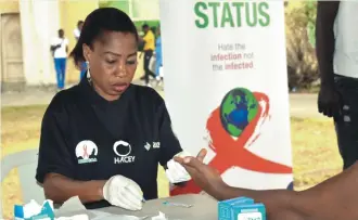  ??  ?? A medic collecting blood sample for HIV test as part of the programme by Access Bank and its partners during the week of the 2020 Lagos City Marathon