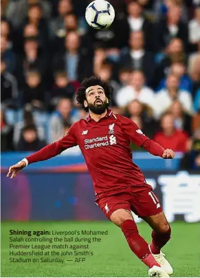  ?? — AFP ?? Shining again: Liverpool’s Mohamed Salah controllin­g the ball during the Premier League match against Huddersfie­ld at the John Smith’s Stadium on Saturday.