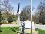  ?? CONTRIBUTE­D PHOTO ?? Mike Shea of Winsted raises a flag in honor of organ donation at Charlotte Hungerford Hospital.