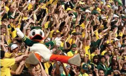  ?? ?? The Oregon Duck mascot is carried by the crowd at Autzen Stadium in Eugene, Oregon. Photograph: Jonathan Ferrey/Getty Images