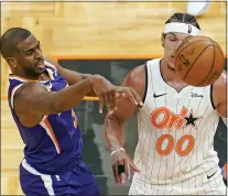  ?? JOHN RAOUX - THE ASSOCIATED PRESS ?? Phoenix Suns guard Chris Paul passes the ball past Orlando Magic forward Aaron Gordon (00) during the second half of an NBA basketball game, Wednesday, March 24, 2021, in Orlando, Fla.