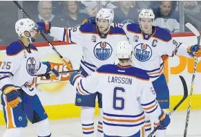  ?? — CP FILES ?? Oilers’ Darnell Nurse, left, Leon Draisaitl, Adam Larsson and Connor McDavid celebrate a goal by Draisaitl during recent NHL action. The scoring exploits of Draisaitl and McDavid are driving the Oilers to the playoffs for the first time in over a decade.