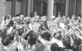  ??  ?? Journalist­s jostle to take pictures of Douglas Mahiya outside Rotten Row magistrate­s’ court in Harare yesterday