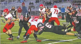  ?? Photograph­s courtesy of Russ Wilson ?? Blackhawks Jesse Undernehr, a senior, and Jonathan Small block the Tigers’ No. 24 Friday night.