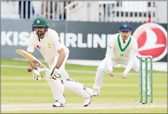  ?? (AFP) ?? Pakistan’s Babar Azam (left), makes a run after playing a shot on the final day of Ireland’s inaugural Test match
against Pakistan at Malahide Cricket Club, in Dublin on May 15.