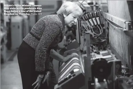  ?? Photo: AFP ?? Britain’s Prime Minister Theresa May visits textile producers Alex Begg during a tour of the United Kingdom on Thursday.