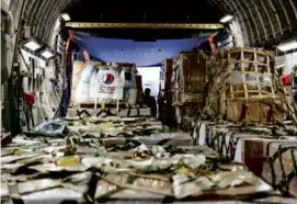 ?? MOFA QATAR/AFP VIA GETTY IMAGES ?? Boxes inside a Qatari military aircraft that held medicine and other aid for Gaza were unloaded in Egypt Wednesday.