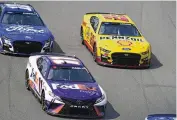  ?? JEFF ROBERSON / AP ?? Joey Logano (22) races alongside Denny Hamlin (11) and Aric Almirola (10) during a NASCAR Cup Series race at World Wide Technology Raceway, Sundayin Madison, Ill. Logano ended up winning the race.