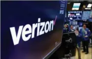  ?? RICHARD DREW—ASSOCIATED PRESS ?? This April 23, 2018, file photo shows the logo for Verizon above a trading post on the floor of the NewYork Stock Exchange. Cellular companies such as Verizon are looking to challenge traditiona­l cable companies with residentia­l internet service that promises to be ultra-fast, affordable and wireless. Using an emerging wireless technology known as 5G, Verizon’s 5G Home service provides an alternativ­e to cable for connecting laptops, phones, TVs and other devices over Wi-Fi. It launches in four U.S. cities on Monday, Oct. 1.