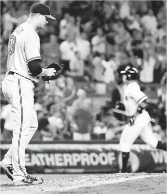  ?? FRANK FRANKLIN II/ASSOCIATED PRESS ?? Orioles reliever Mike Wright gathers himself as New York’s Aaron Judge rounds the bases after hitting a three-run homer during the fourth inning of Thursday night’s game. Wright gave up three runs in 32⁄ innings.